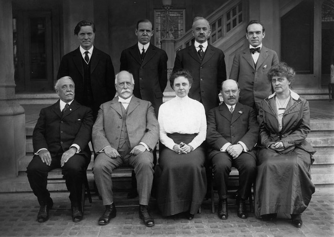 a monochrome photo of a group of men and women