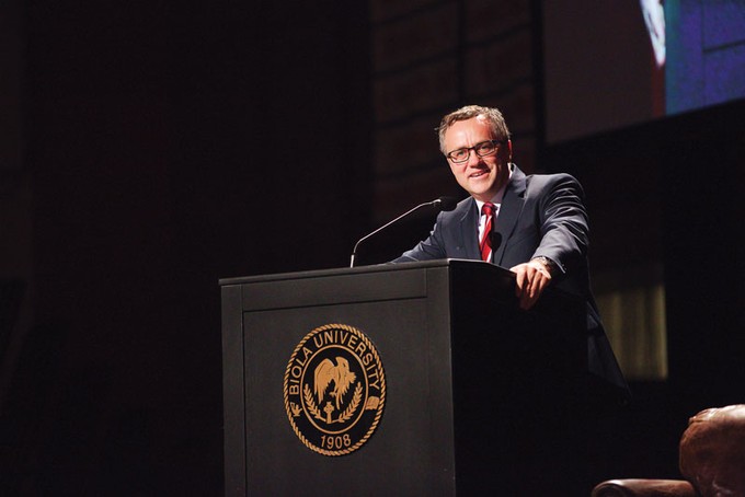 Barry Corey standing behind a podium