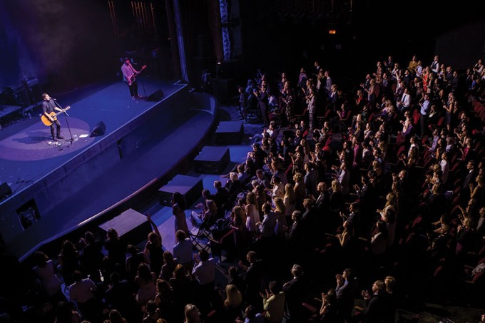 a crowd watching musicians on stage