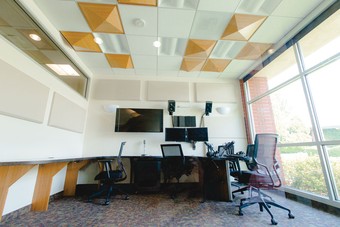 a room with chairs and recording equipment