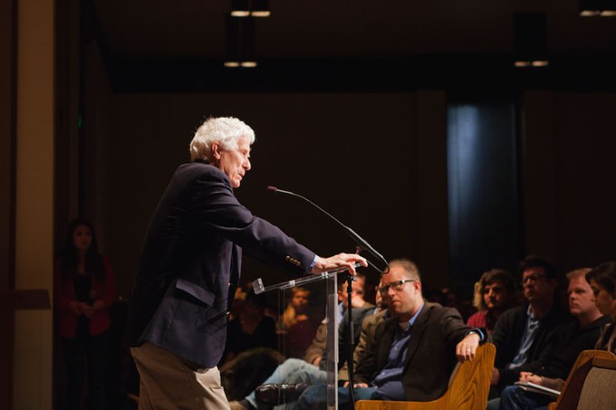 Nicholas Wolterstorff speaking behind a podium to an audience