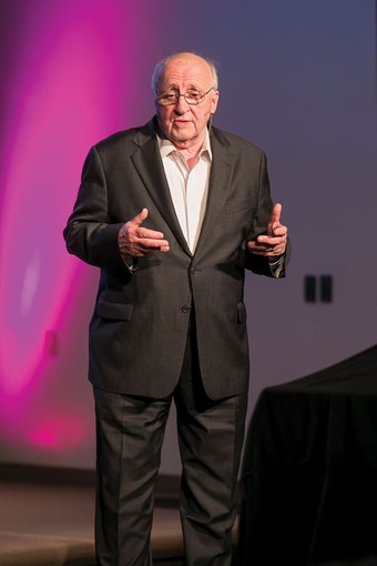 a man talking on a stage