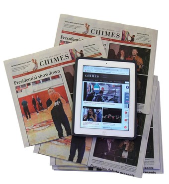 a tablet computer on a stack of Chimes newspapers