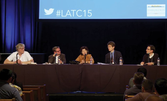 A panel of speakers on stage