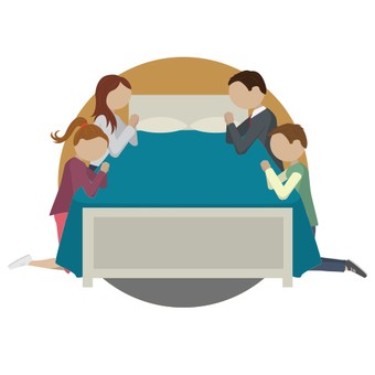 a family kneeling by a bed and praying