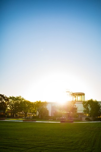 a view of the sun rising over the Biola library