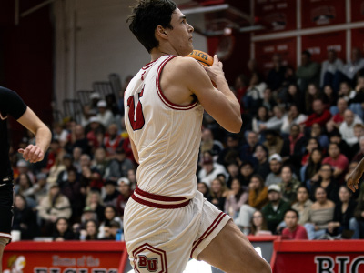 a young man running with a basketball