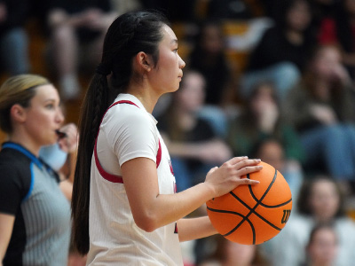 a young woman holding a basketball