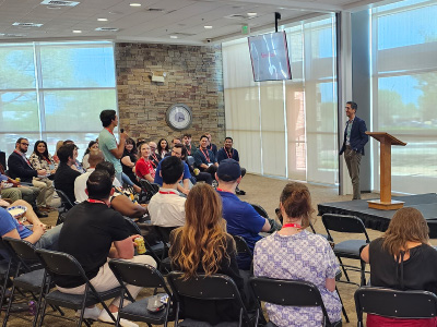 a group of people listening to a speaker