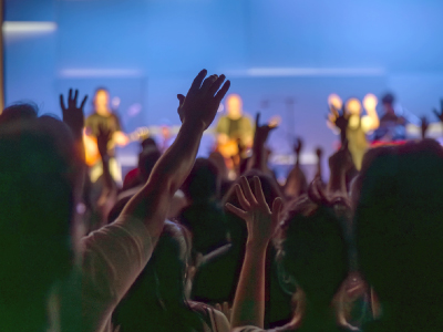 people worshiping with raised hands