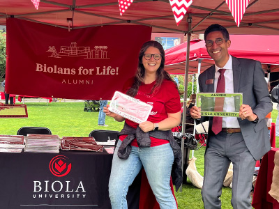 a smiling man and woman posing with license plate frames