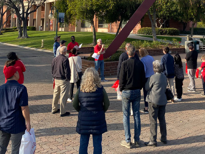 a group of people listening to a tour guide