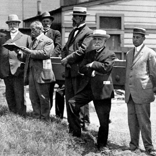 Lyman Stewart standing with a group