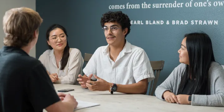young people talking around a table