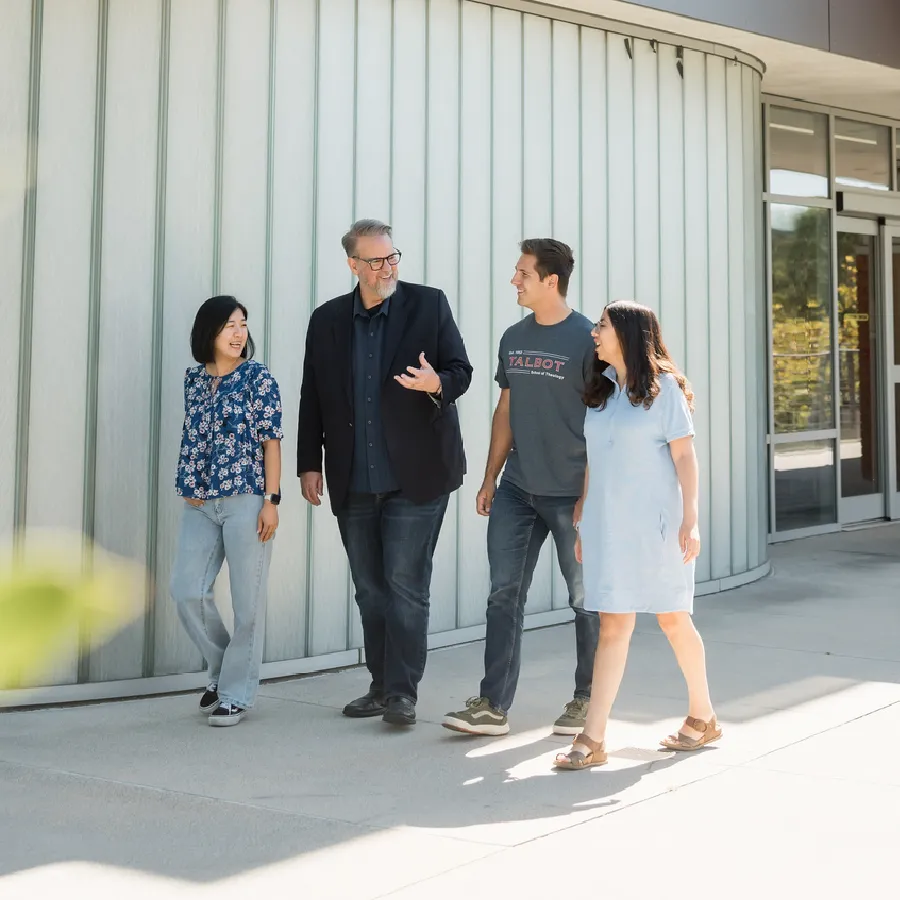 students walking and talking with professor