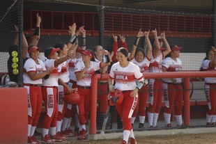 Women softball players cheering