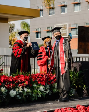 President Barry Corey with graduate